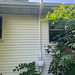 Exterior radon pipe yellow siding