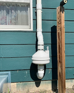 Radon system teal siding home